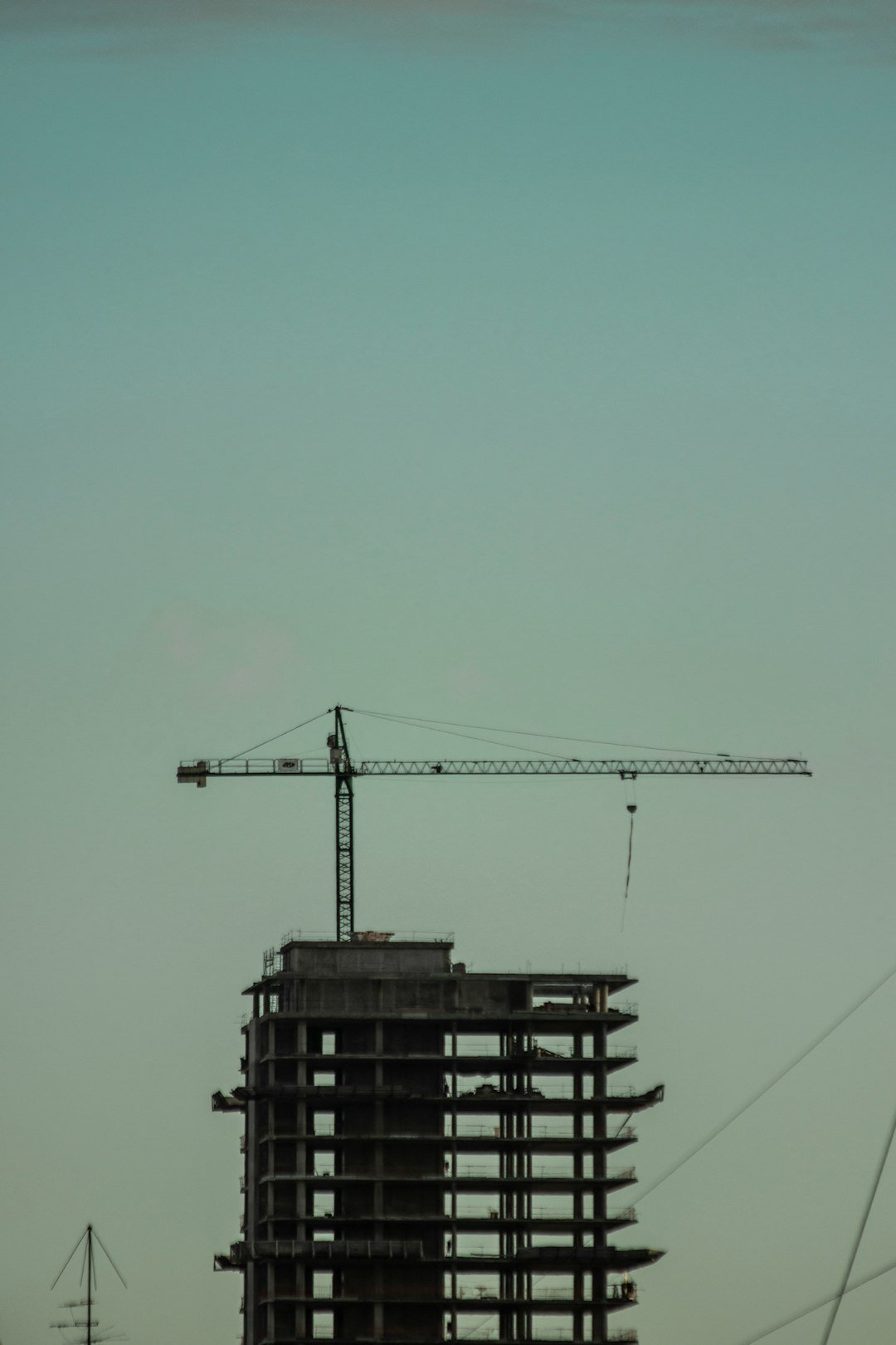 black-crane-under-blue-sky-during-daytime-hywbvpzzr20